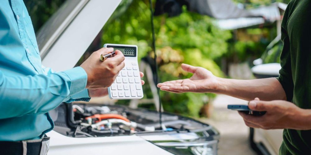 a couple of people standing next to a car
