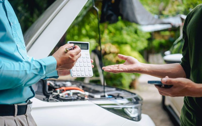 a couple of people standing next to a car