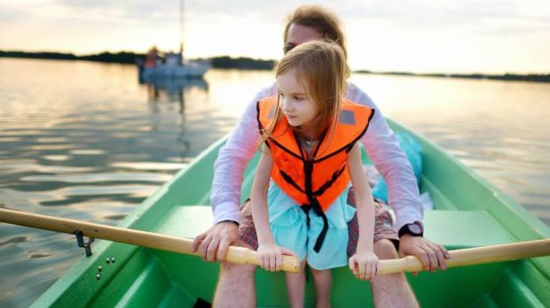 A father and daughter on a row boat together