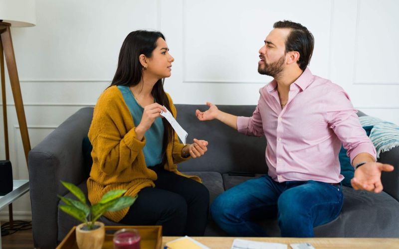 A man and a woman discussing debt responsibilities after separation