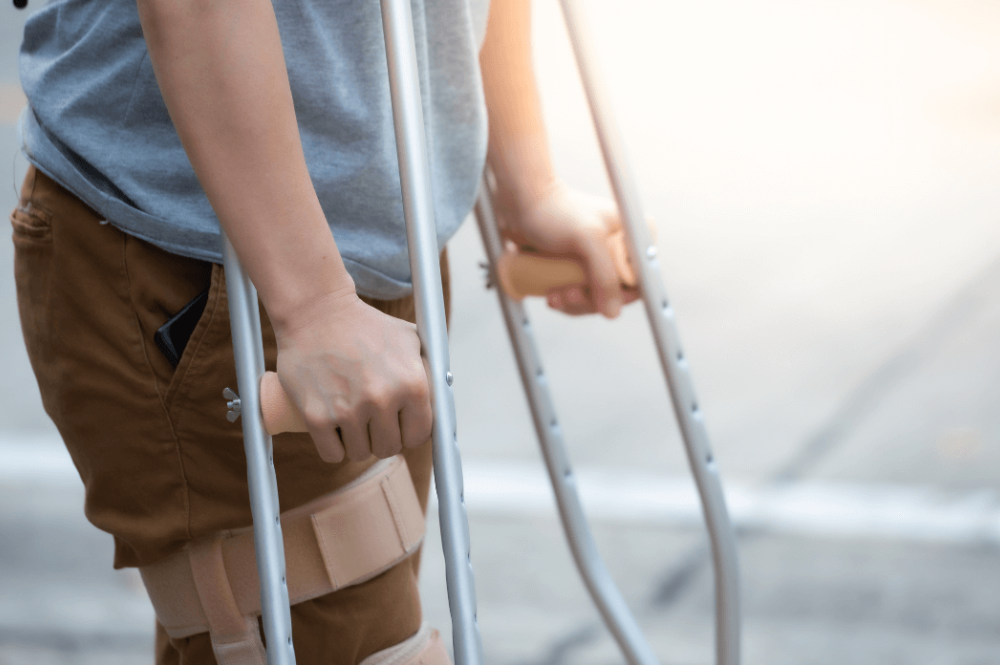 Injured man using crutches