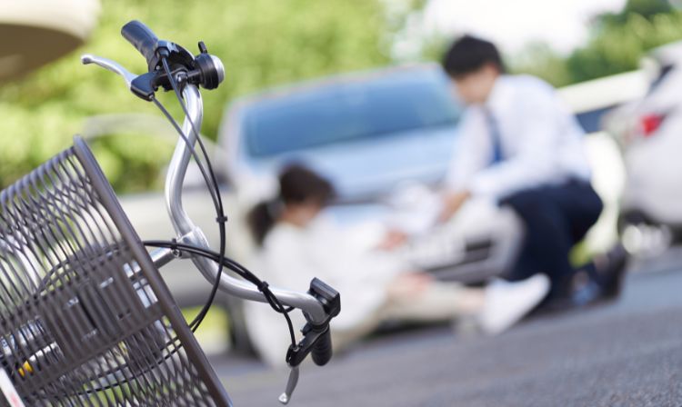 bicycle fallen over with couple in background