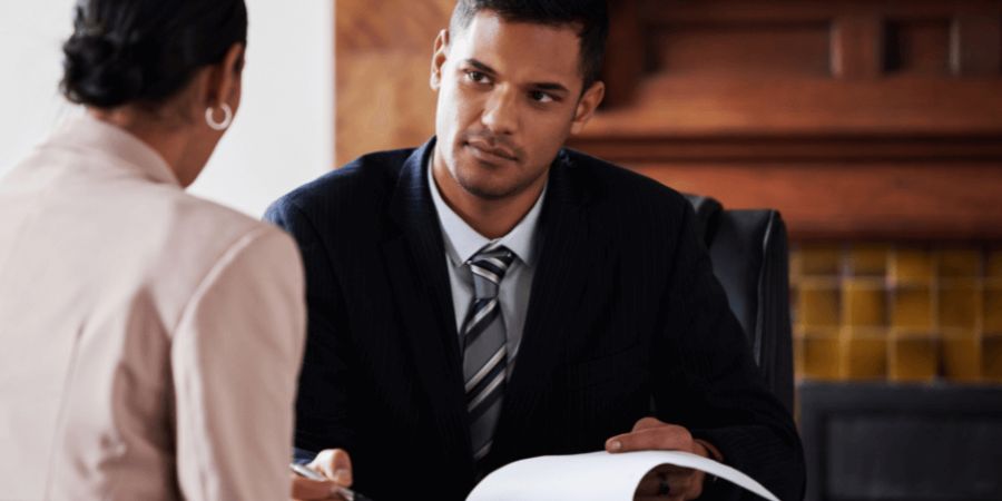 Man reviewing documents with woman in office setting