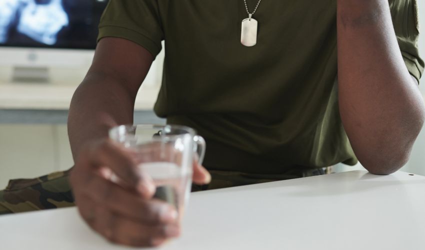 Marine sitting down drinking water