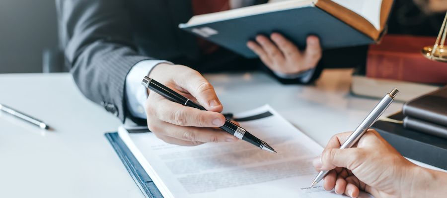 lawyer pointing at paperwork with his pen