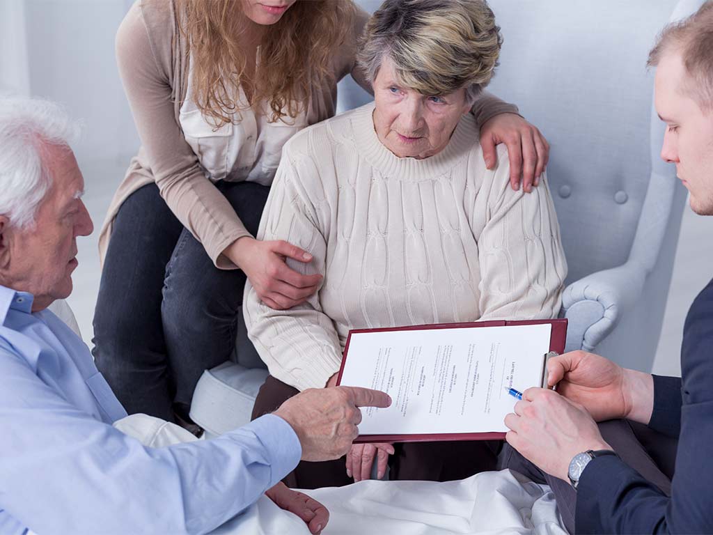 family looking over a will in front of a lawyer