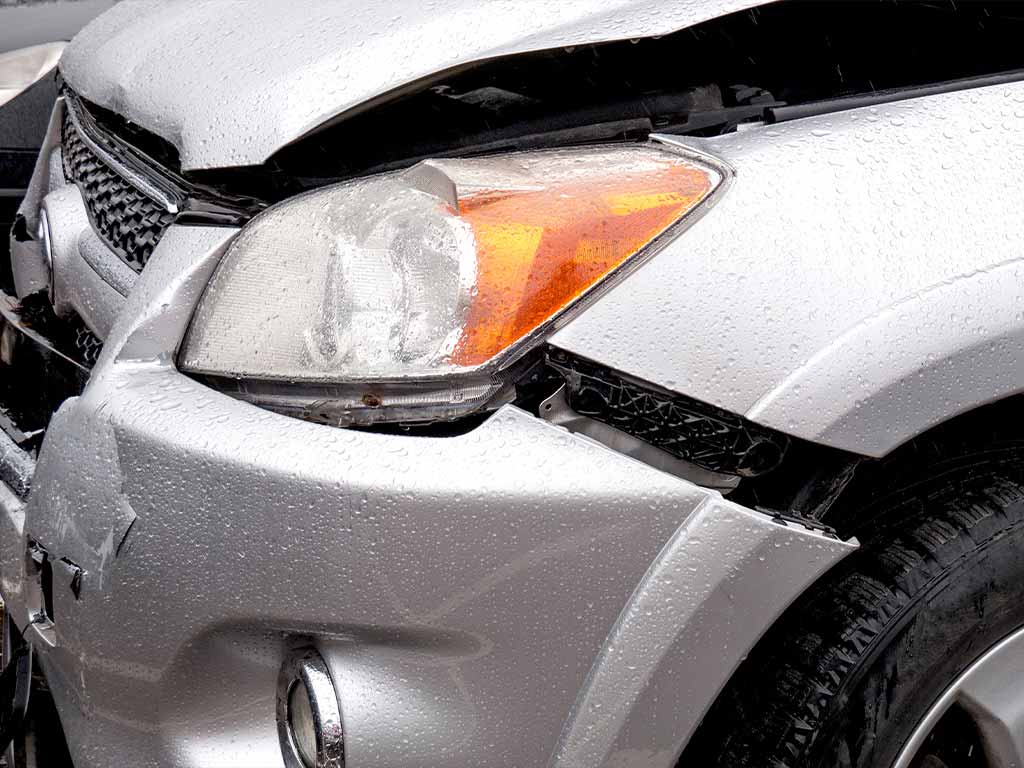 A gray car with front end damage