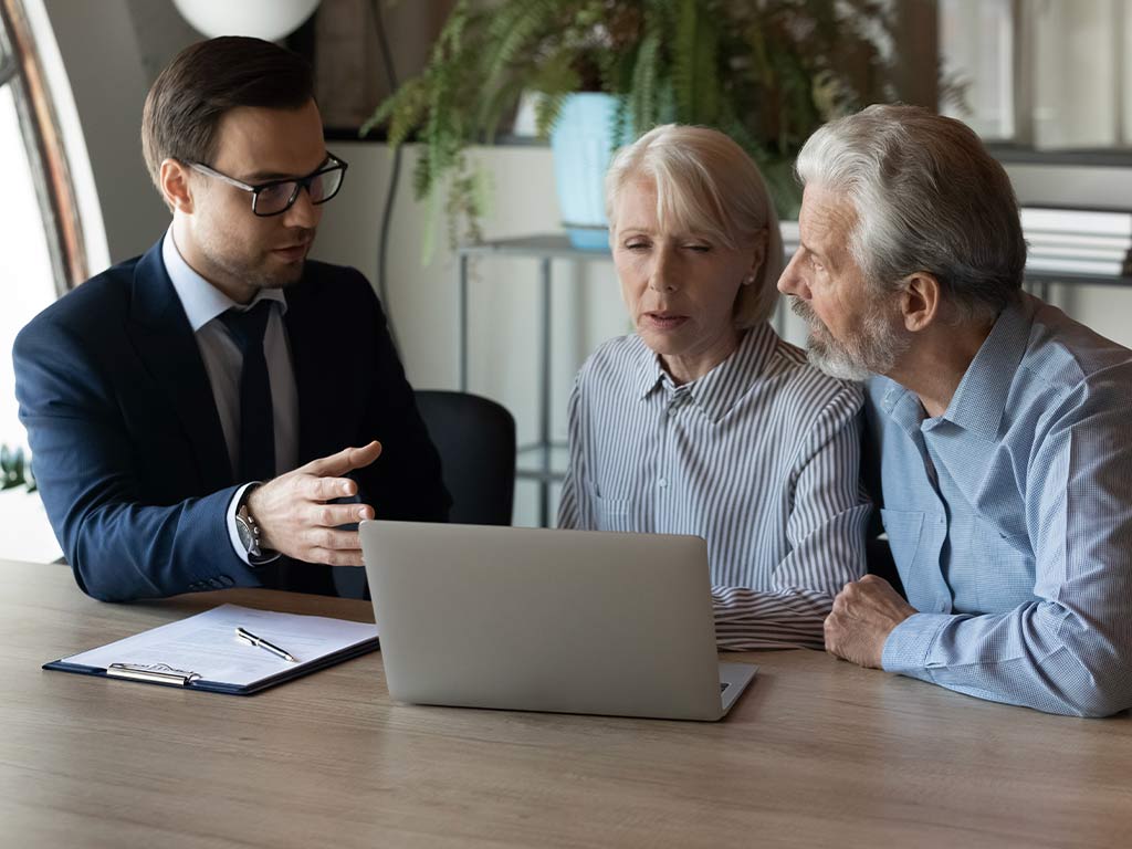 A lawyer talking to an elderly couple 