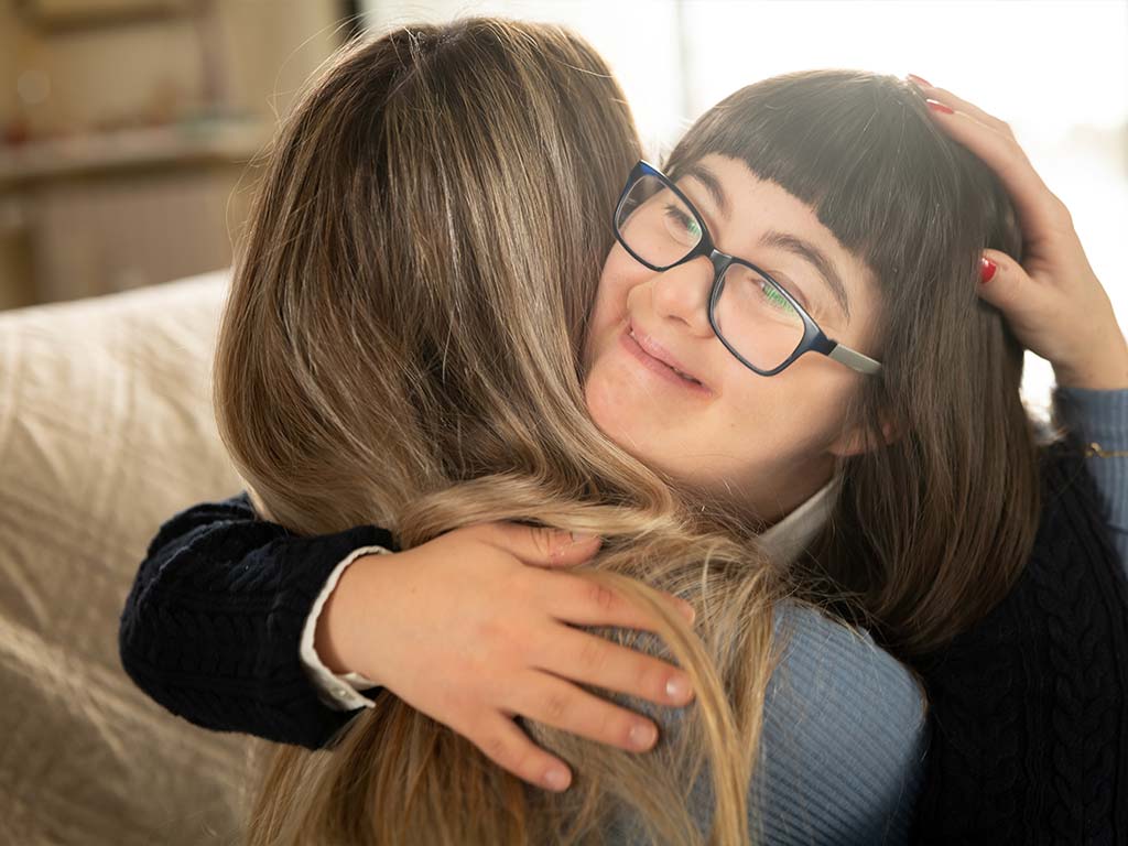 A mother hugging her daughter with special needs