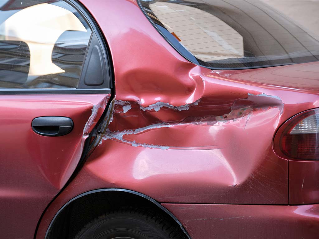 A red car with damage to its side