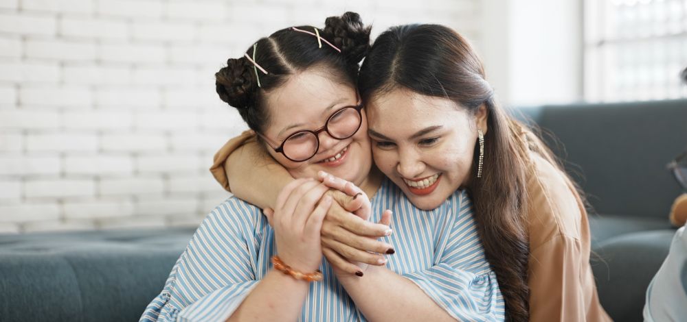 mother hugging her daughter with special needs