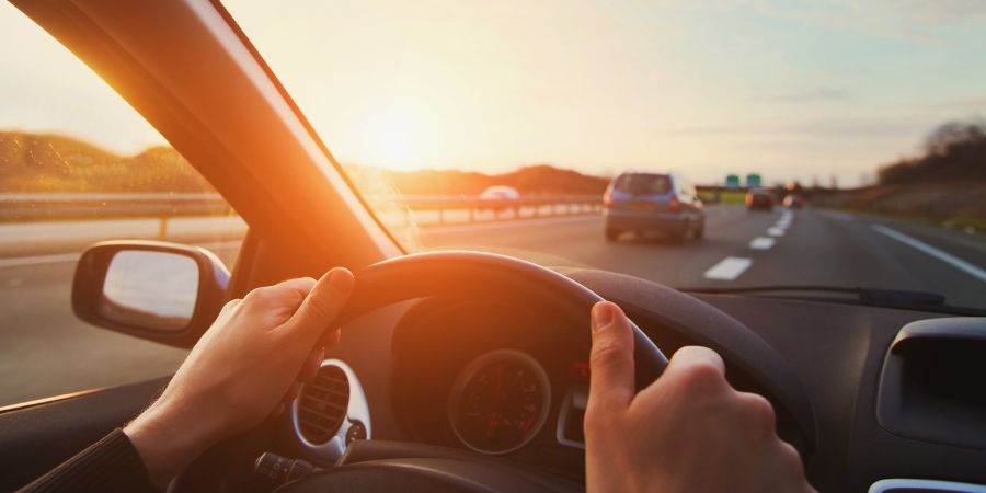 Man driving on the highway at sunset