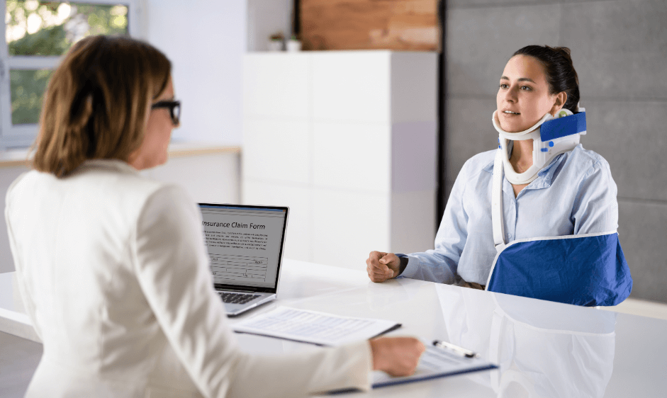 Woman with her neck in a cast speaking to a lawyer