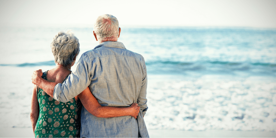Elderly couple looking out at the ocean