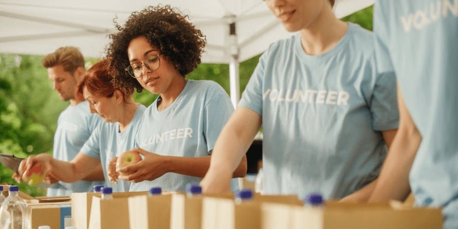 Group of volunteers working on packing lunches