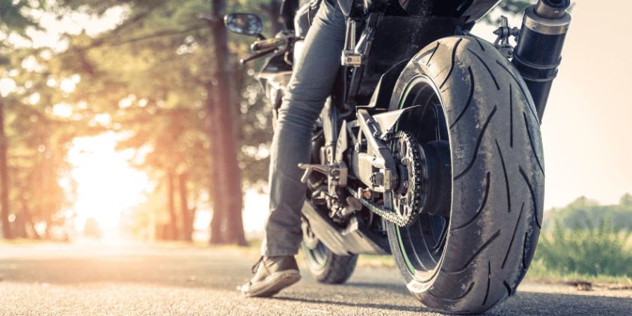 rider on motorcycle in roadway at sunrise