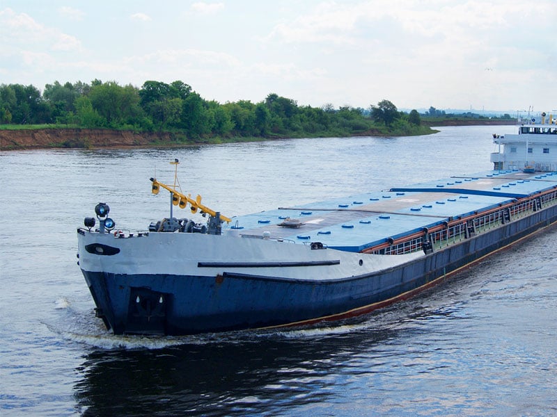 a barge ship transporting cargo across the sea