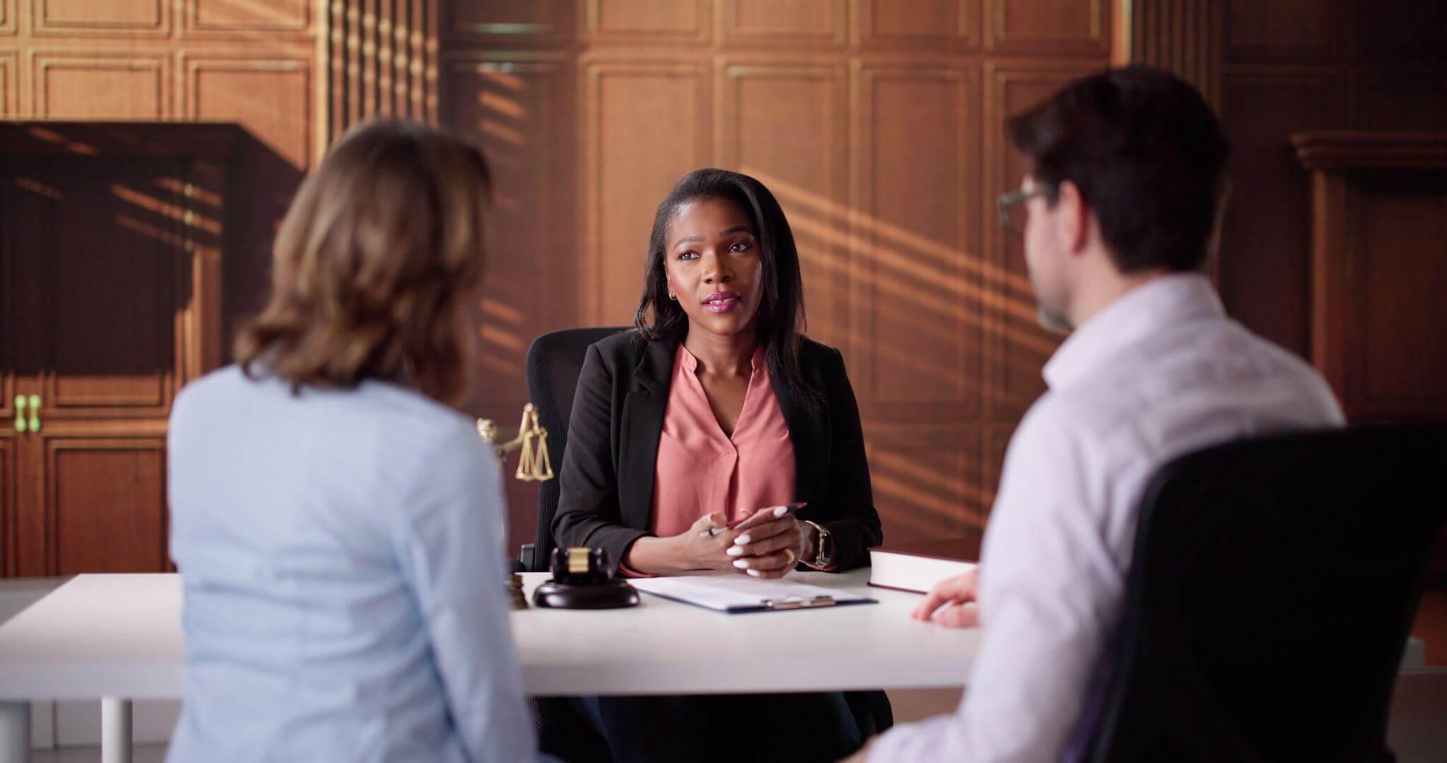 A woman consulting with a family law attorney at a table
