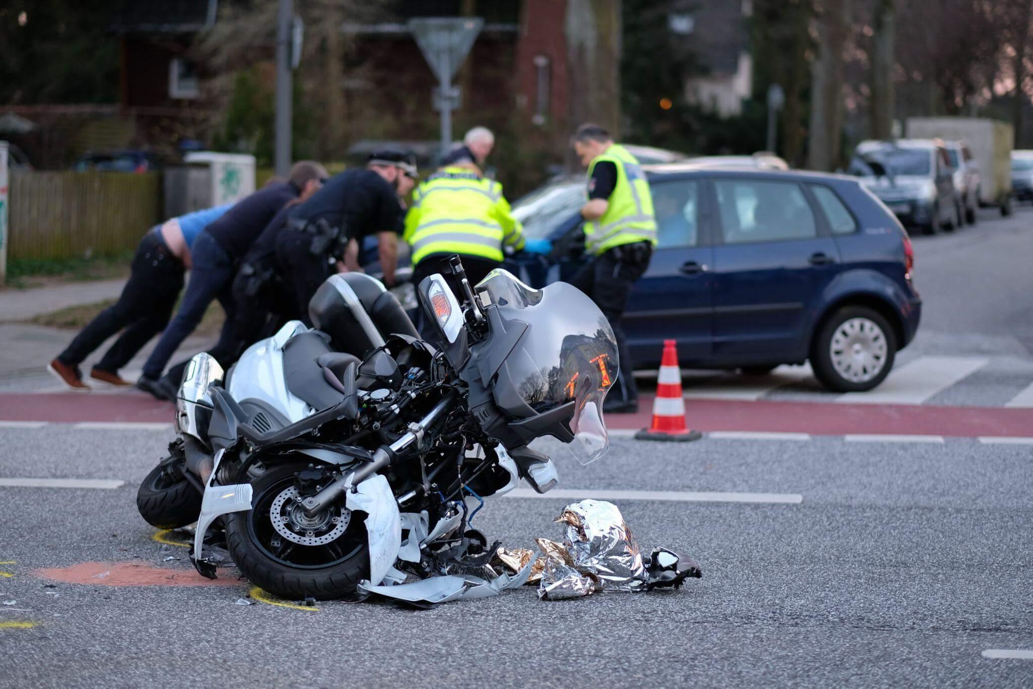 a motorcycle that is laying on its side in the street